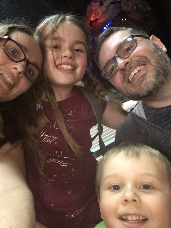 A Family of four smile in a selfie