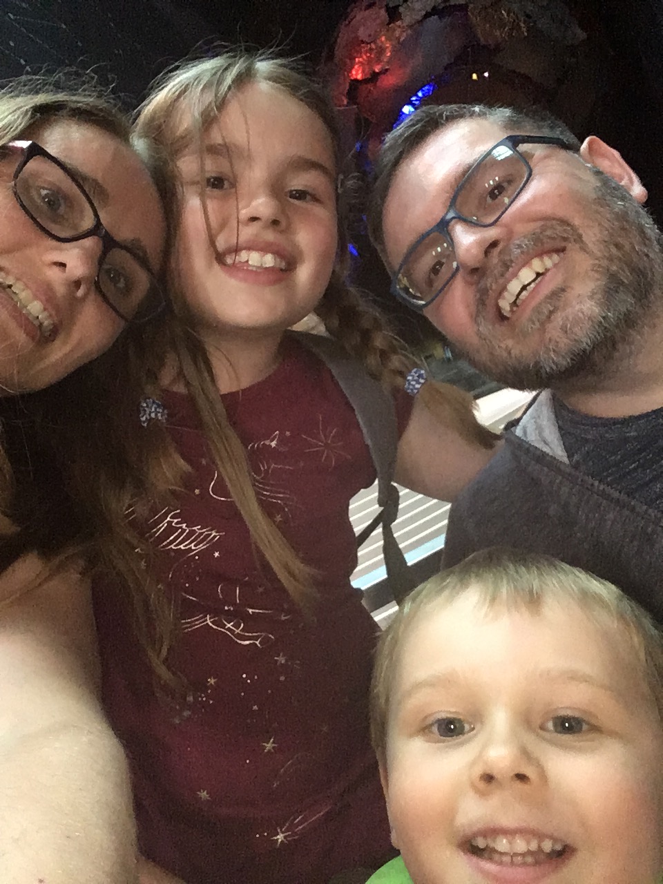 A Family of four smile in a selfie