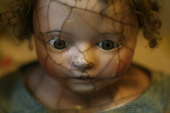 heavily cracked face of a porcelain doll