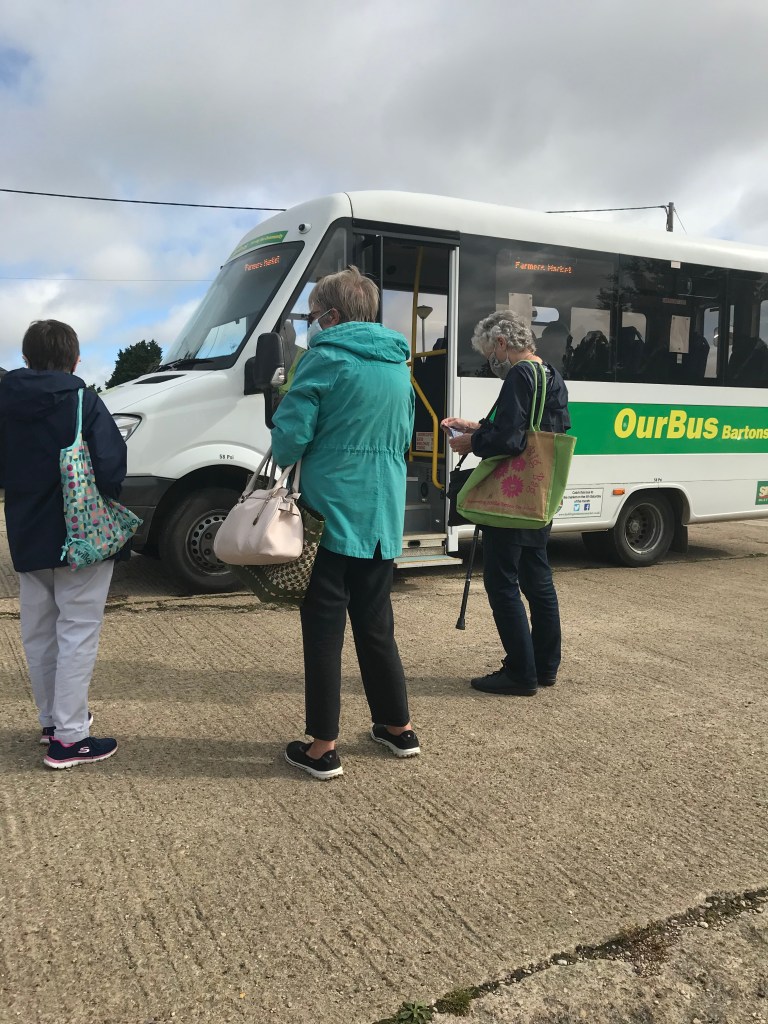 passengers wearing masks boarding a bus