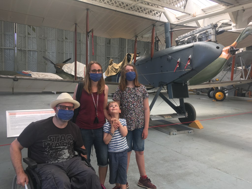 a family of four wearing masks