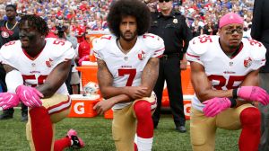 3 American footballers kneeling