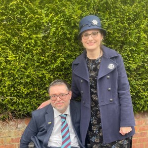 A couple pose in smart clothes. 